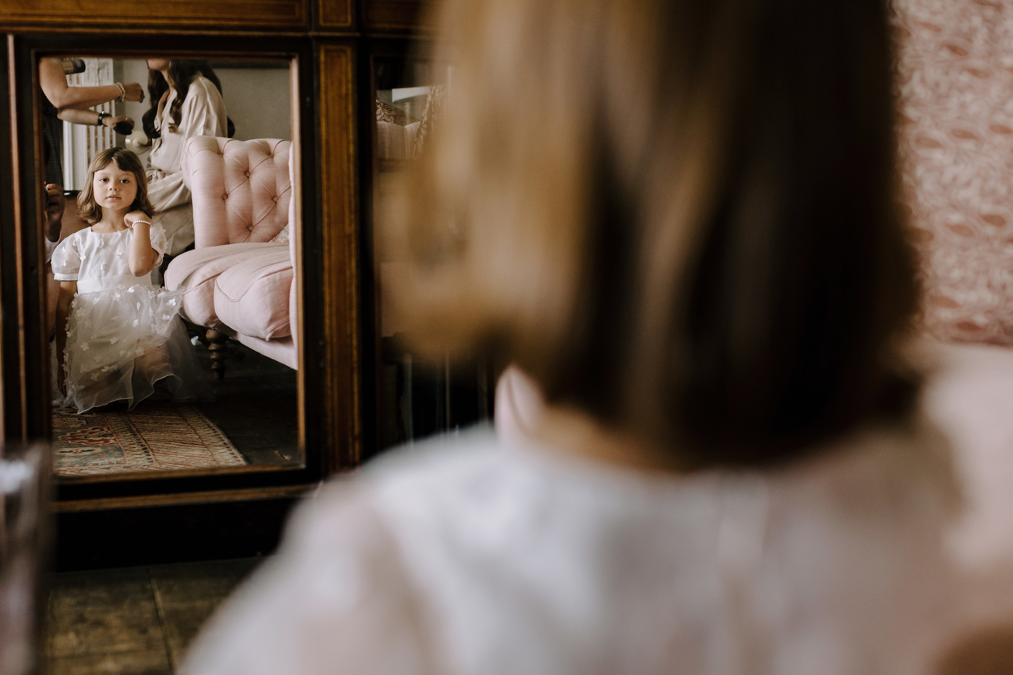 Flowergirl sat in front of the mirror looking at her reflection