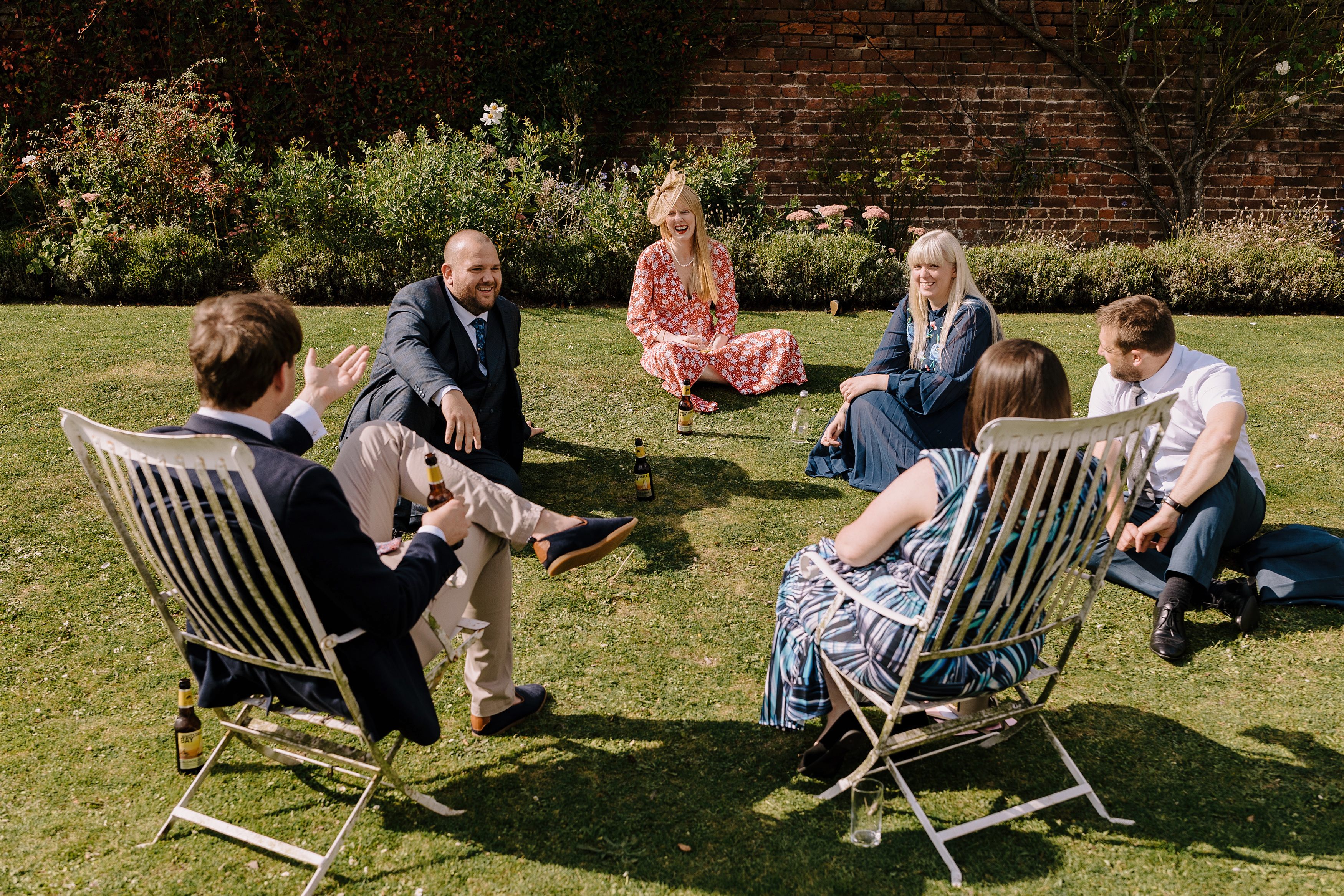 Wedding guests relax in the walled garden at Goodnestone Park