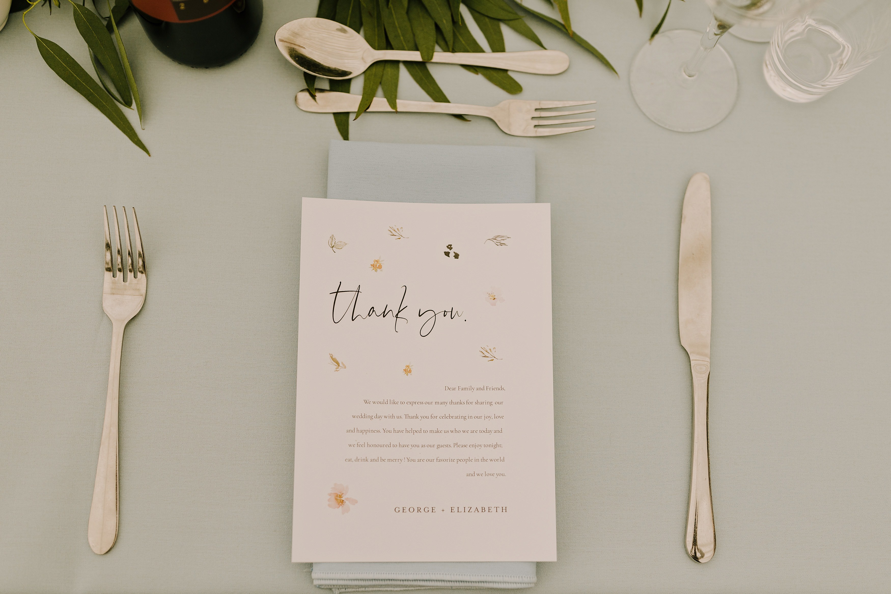 A photo showing a wedding table place setting