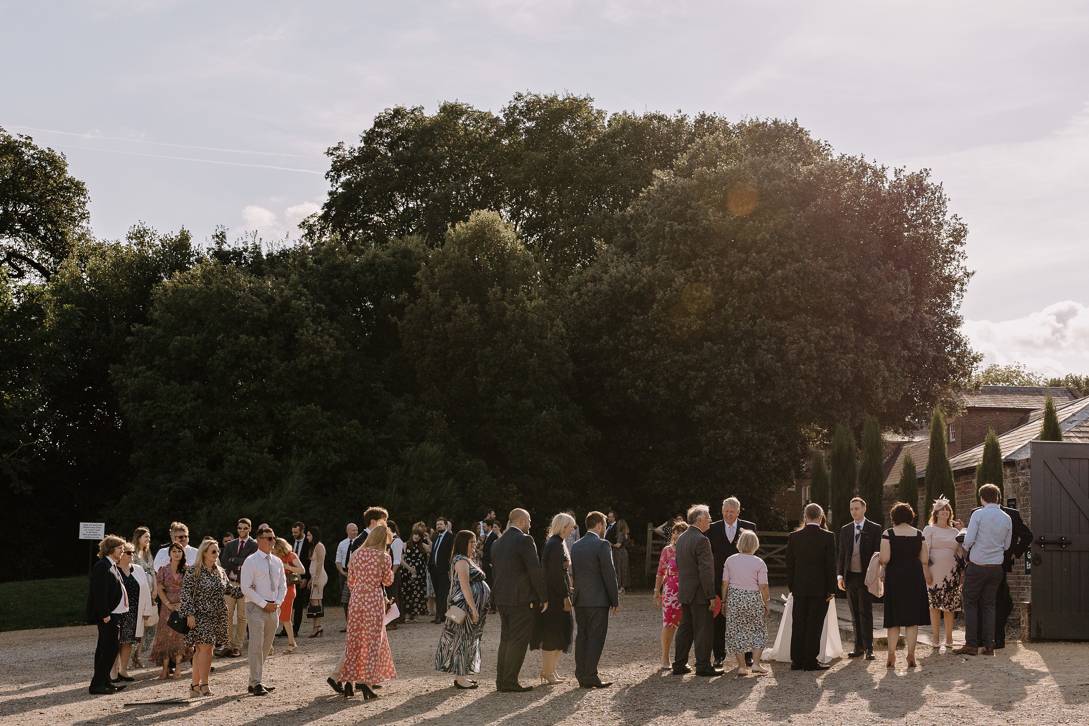 Wedding guests entering the wedding reception and being greeted by the bride and groom