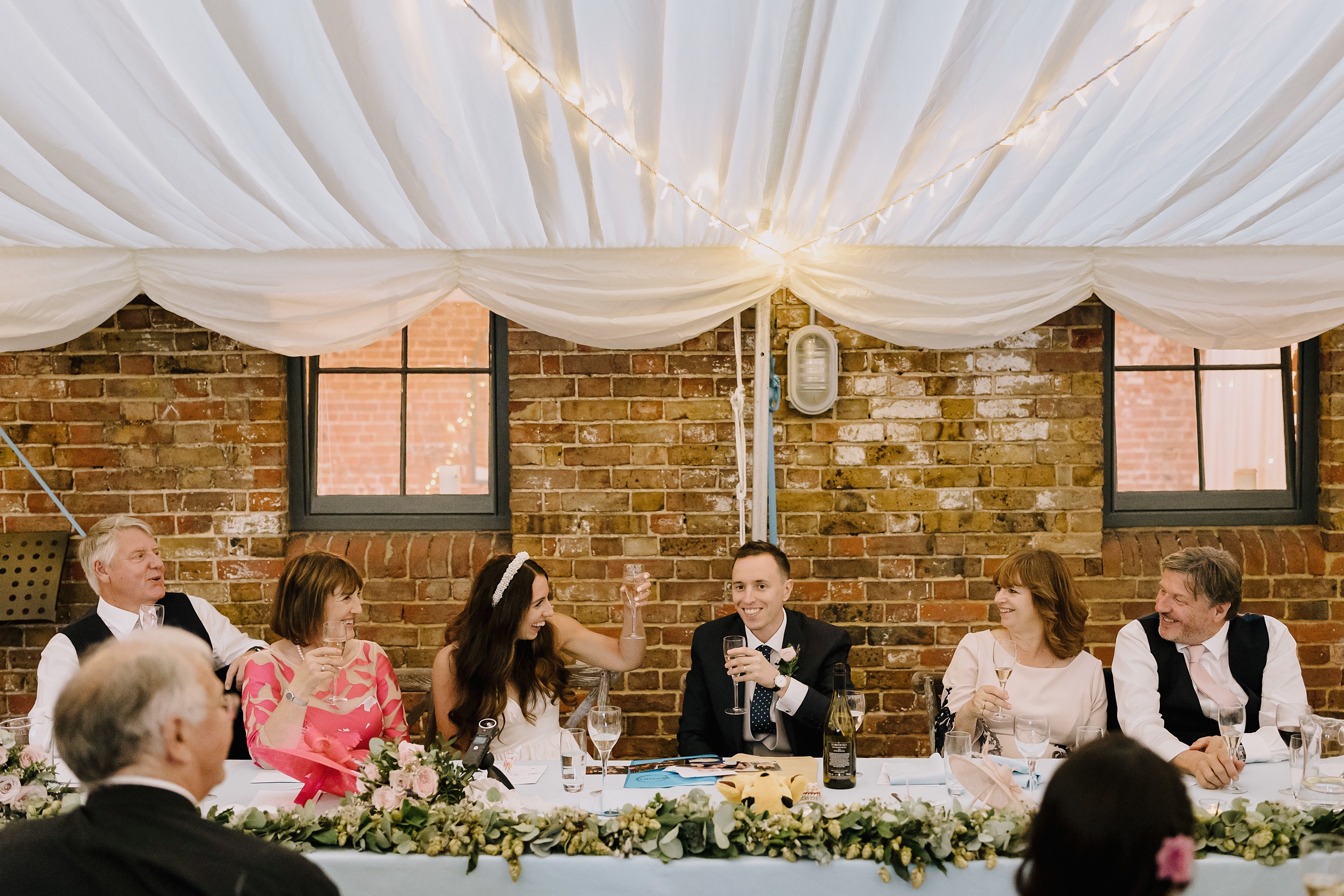 The top table toasting after the wedding speeches