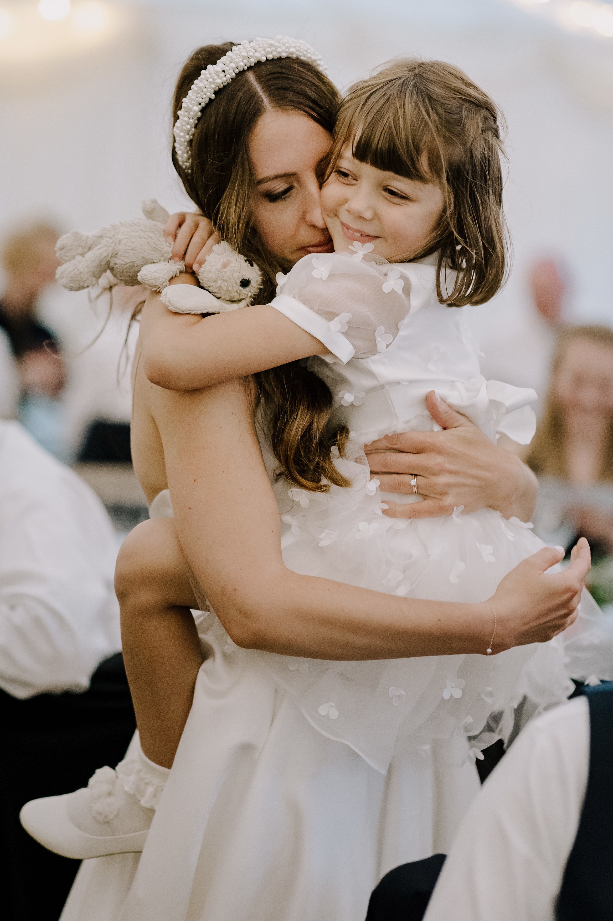 The bride carrying one of her flower girls