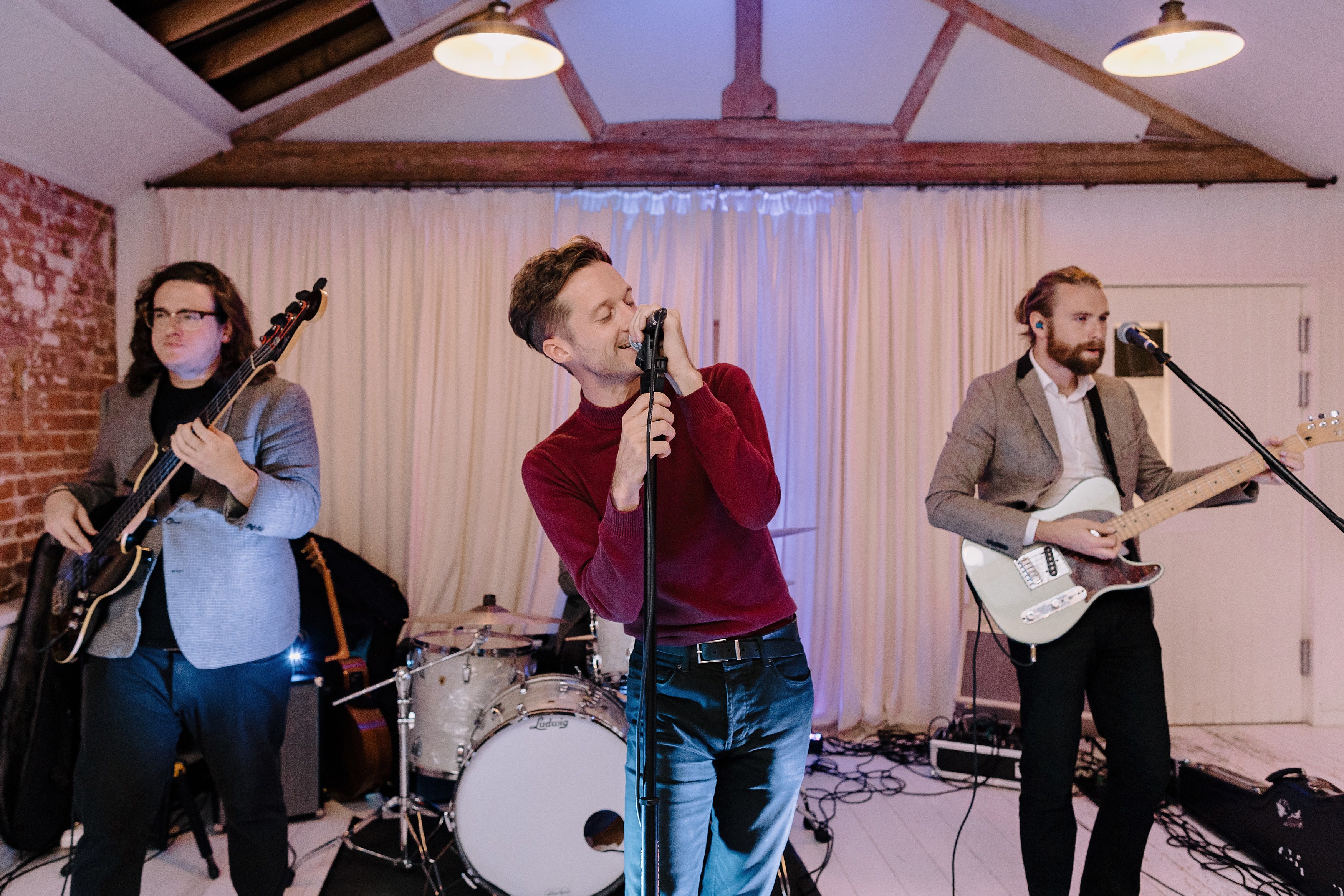 The lead singer and wedding band having a good time whilst performing