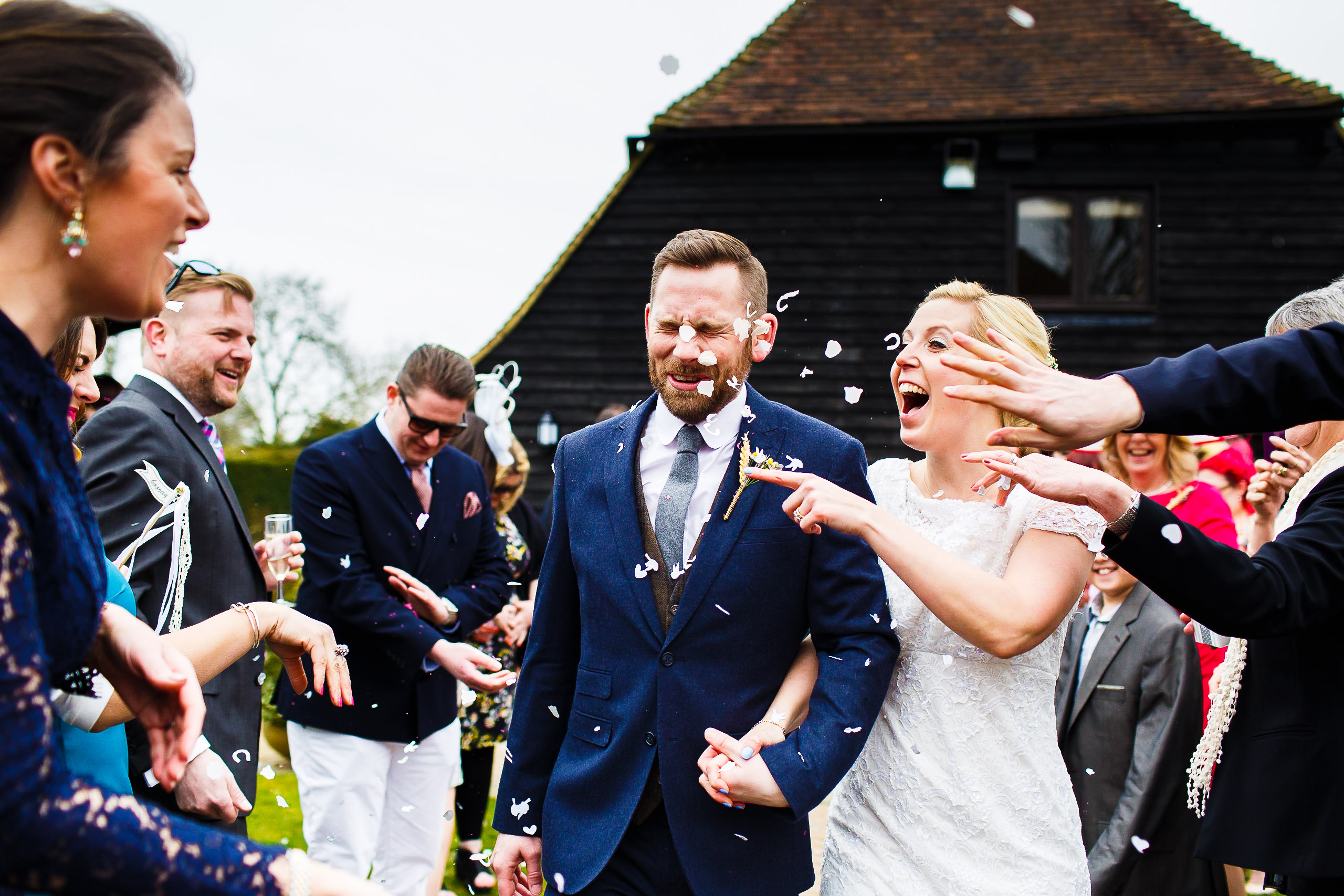 Karen and Duncan have confetti thrown at them after their wedding ceremony