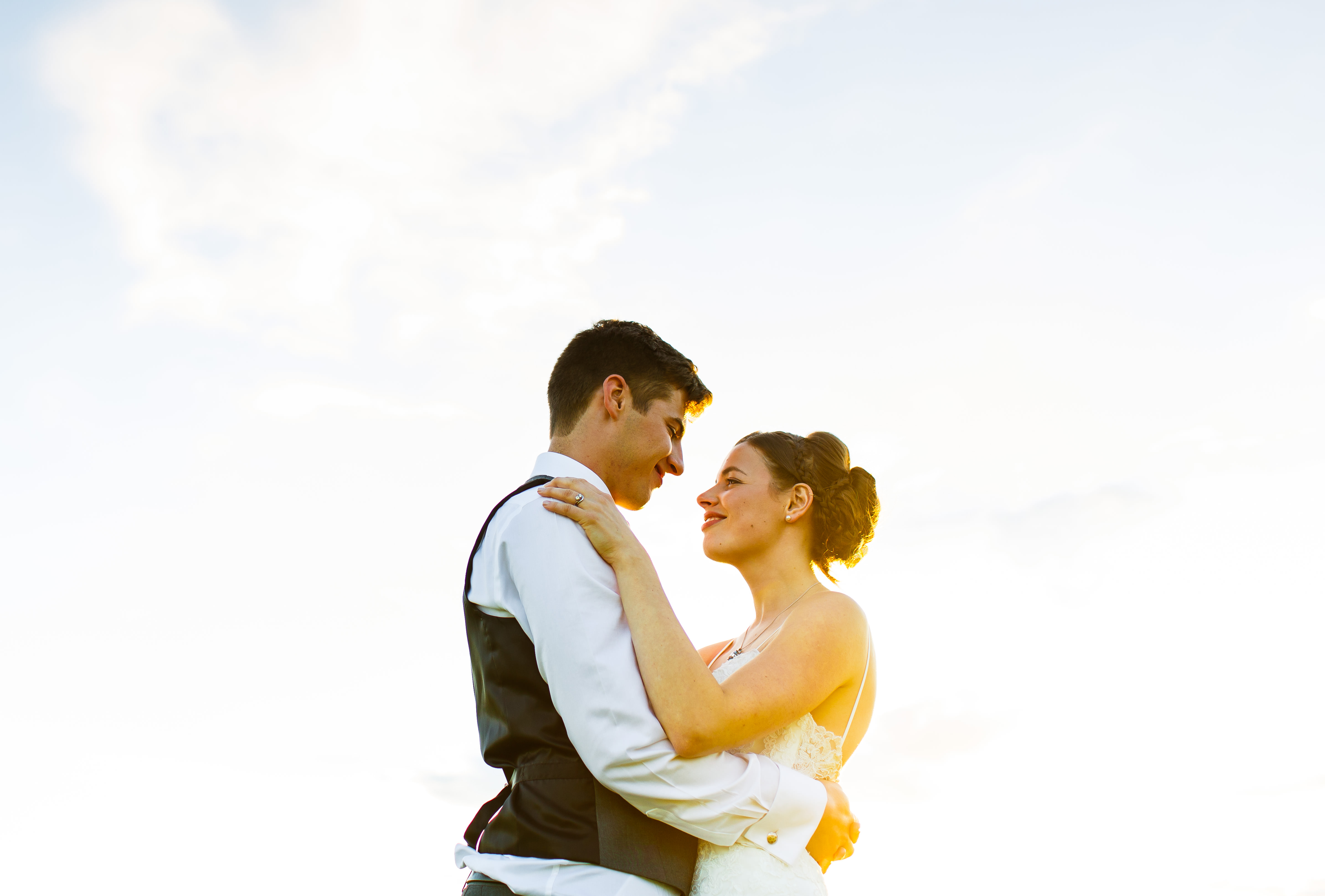 Image of beautiful couple holding each other during the sunset captured by Kent wedding photographer
