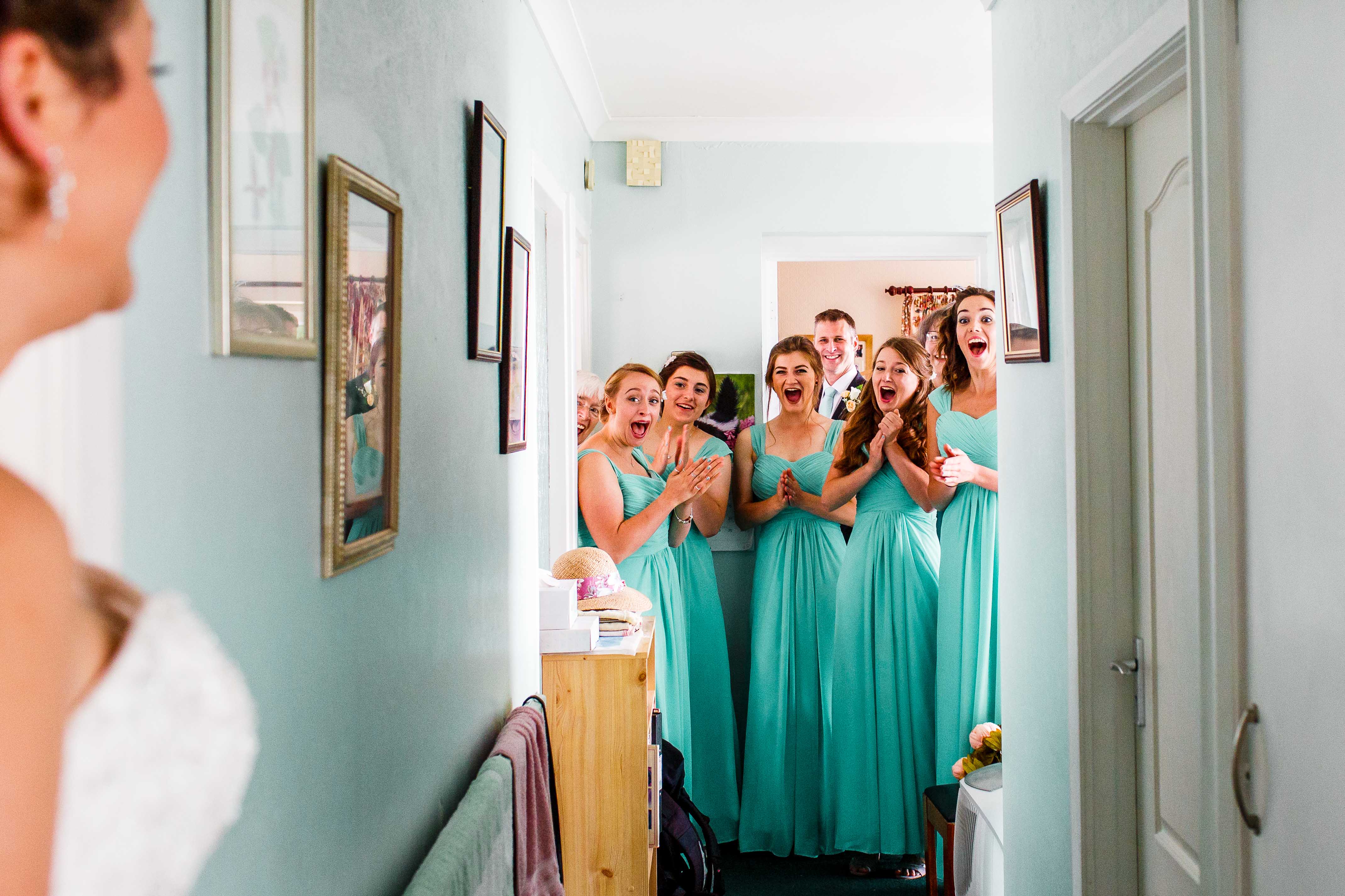 Bridesmaids get really excited when they see the bride for the first time on the wedding day.