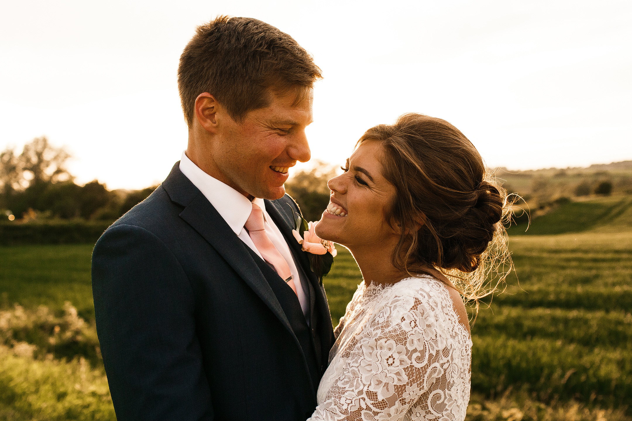 Couple looking at each other lovingly as the sun sets