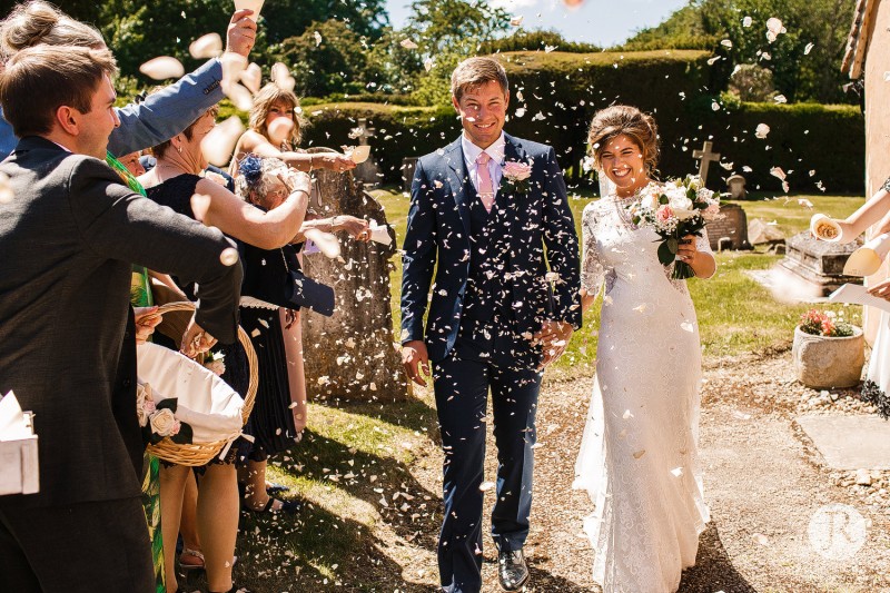 Couple walking through the confetti throw