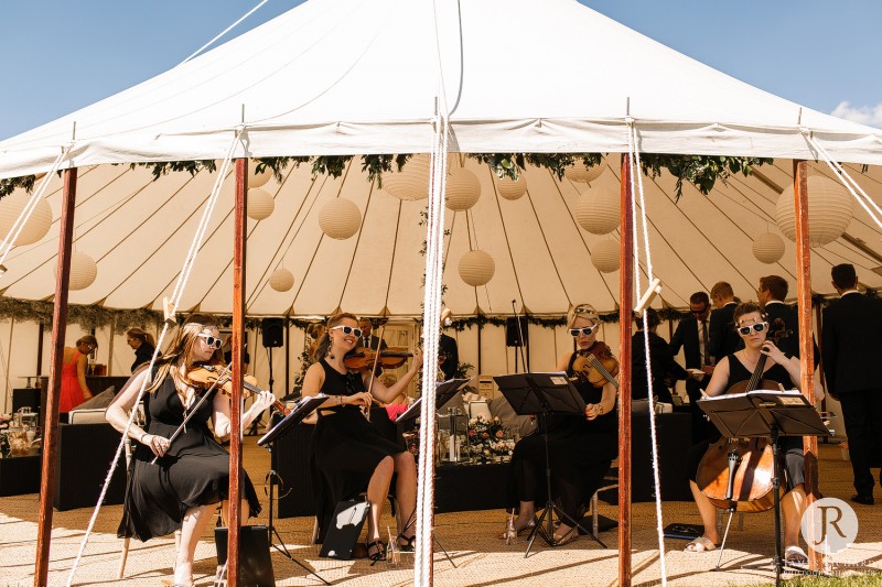 musicians playing music in wedding marquee