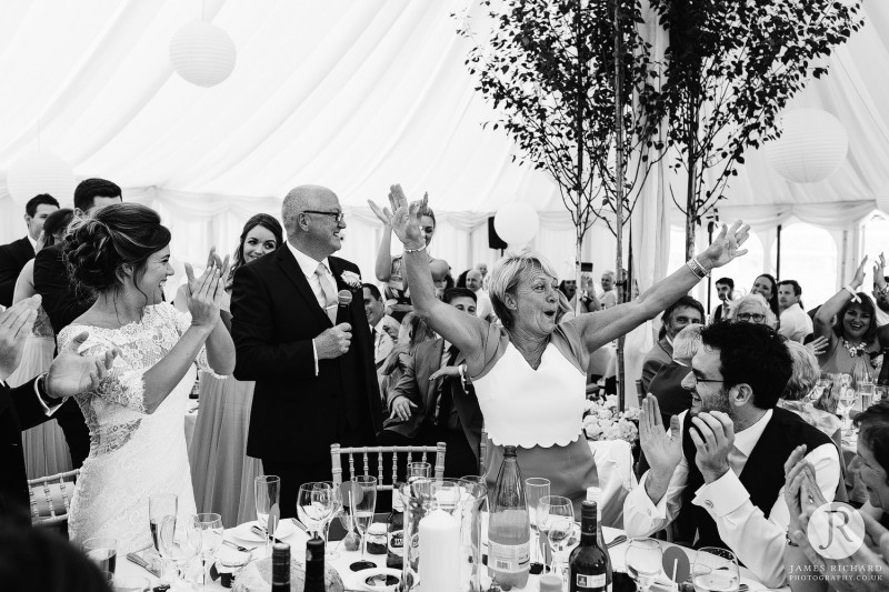 Mother of the bride with her hands up in the air