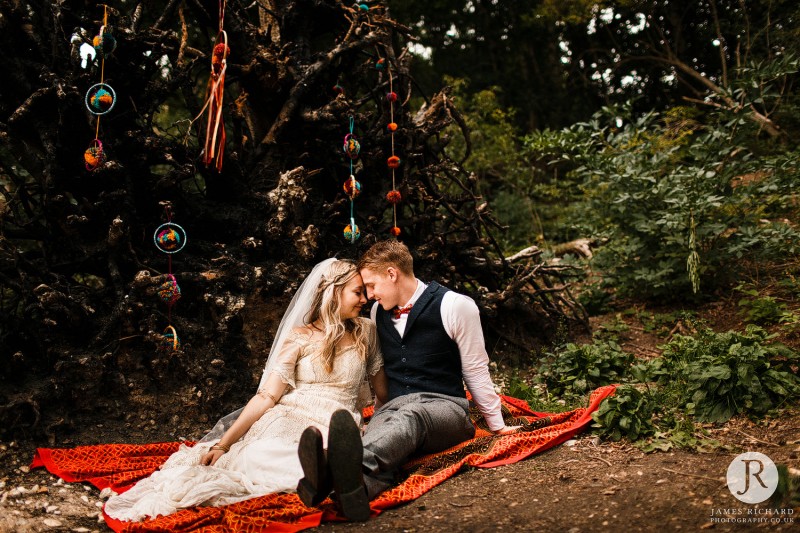 Couple sitting in woodland with beautiful decorations