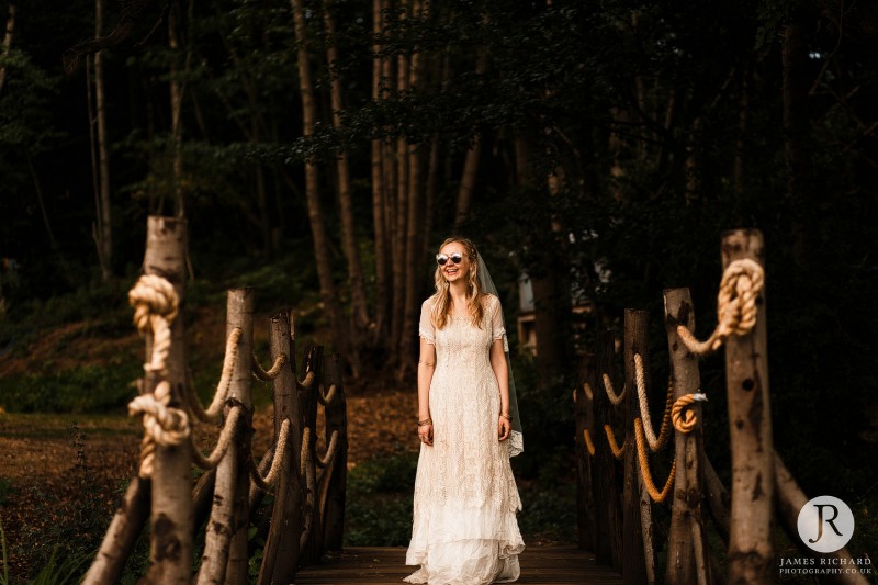 Boho bride with sun glasses smiling at Boho styled shoot at Wilderness Weddings Kent 