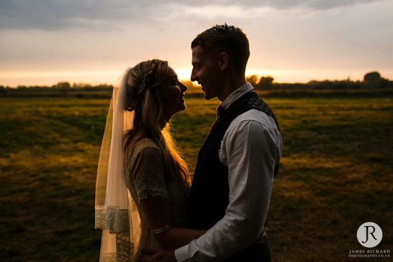 Couple at the sunset looking into each other's eyes at Boho styled shoot at Wilderness Weddings Kent