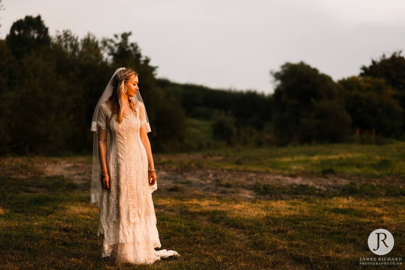 Boho Bride at the stunning wilderness wedding venue in Kent during sunset.