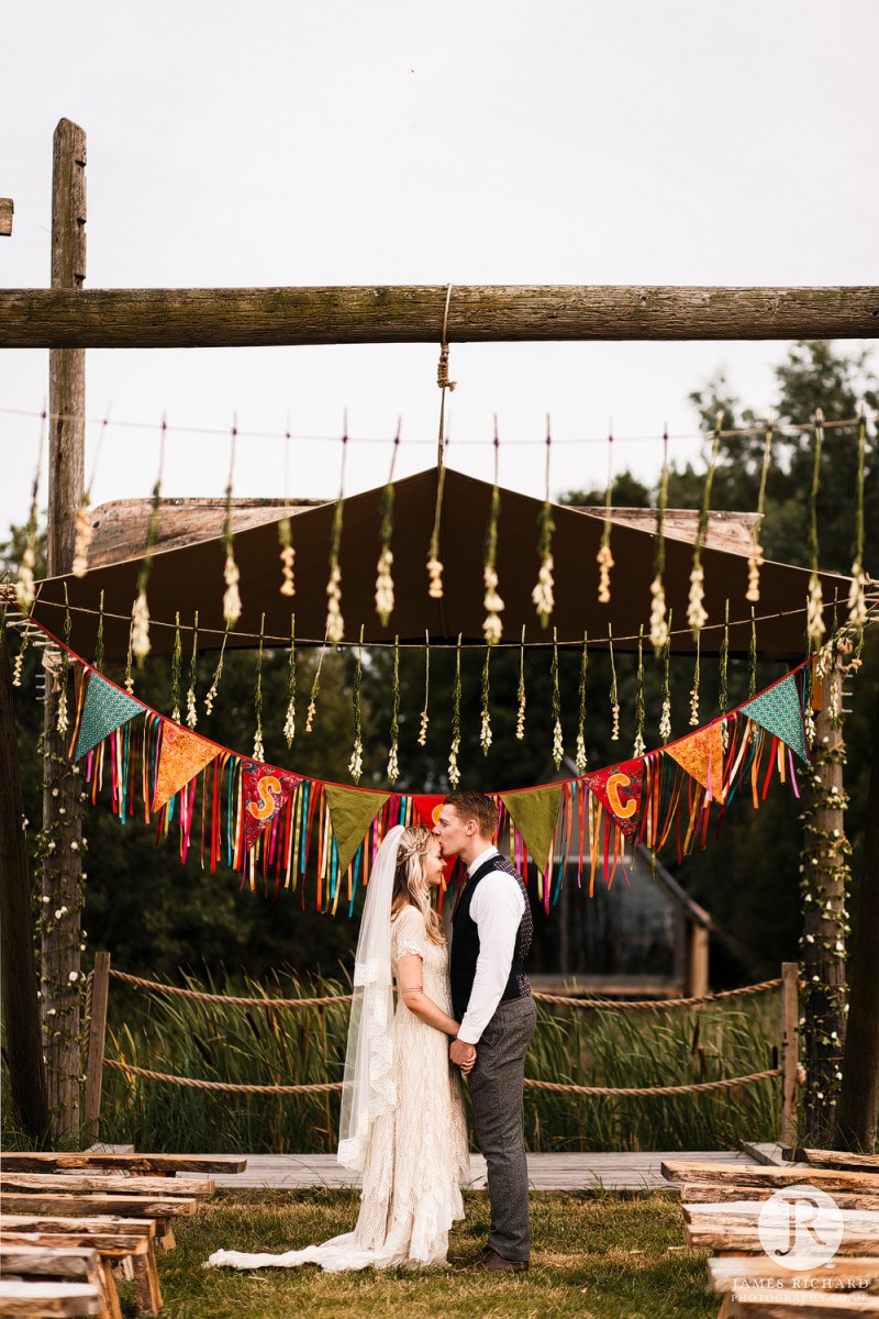 Cute couple kiss during boho styled shoot