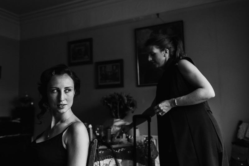 bridesmaid having make up done during alternative wedding