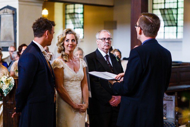 Alternative brides looks lovingly into her groom