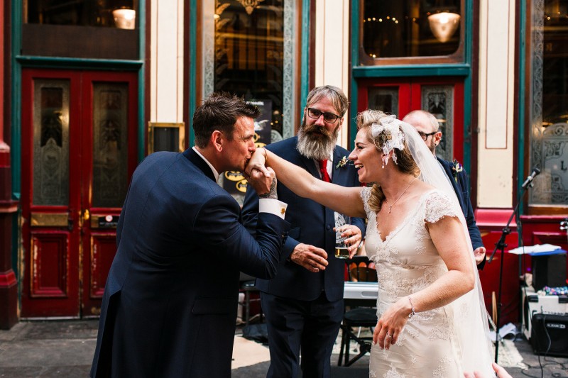 groom kisses his bride's hand