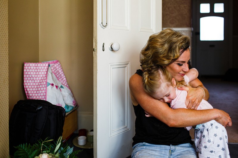 Alternative bride hugs her daughter 