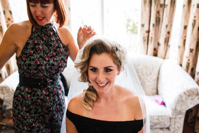 Bride puts her veil on during her alternative wedding